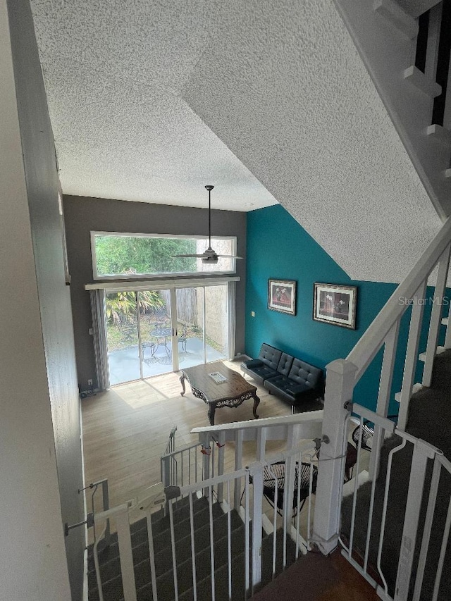 stairway featuring a textured ceiling
