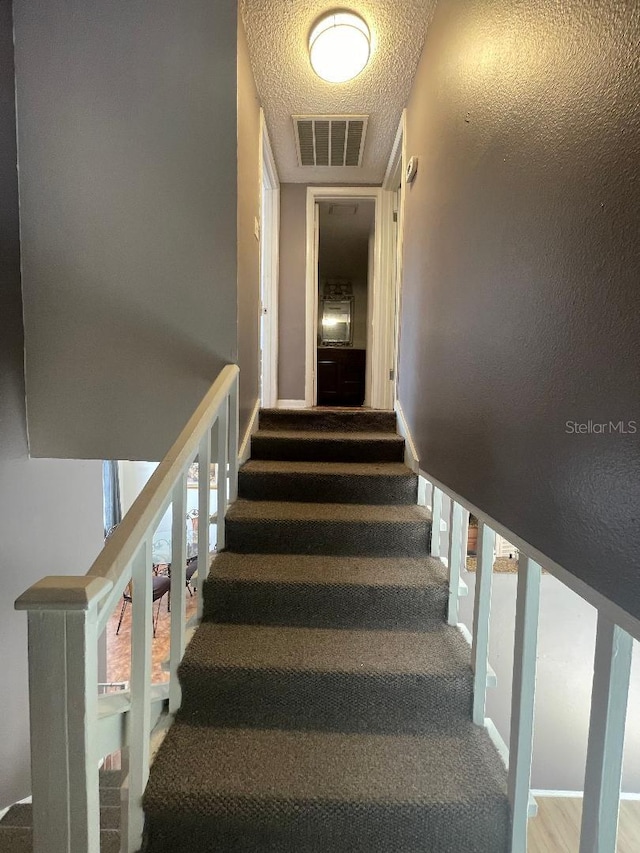 stairs with carpet and baseboards
