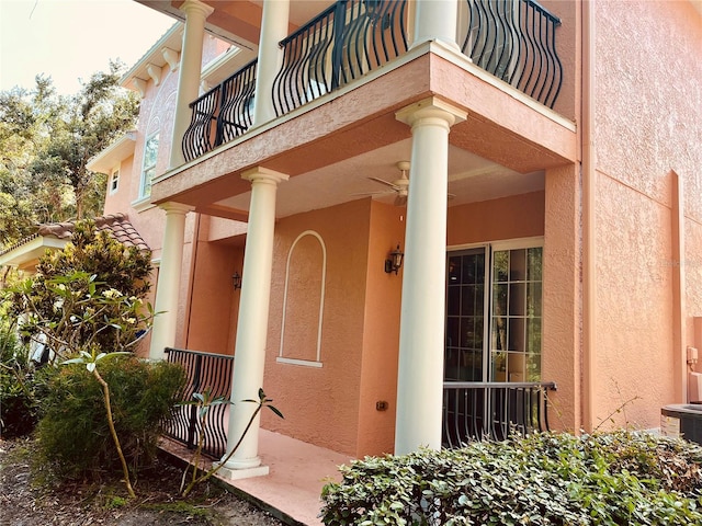 184 Banyan Bay Dr, Saint Petersburg, FL 33705 - property entrance with a balcony, stucco siding, and central AC unit