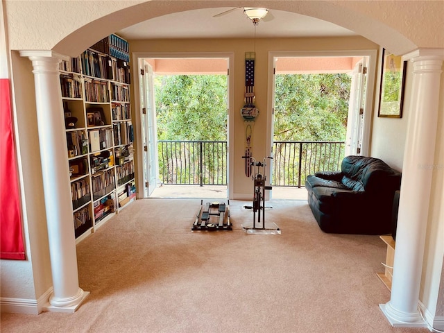 184 Banyan Bay Dr, Saint Petersburg, FL 33705 - sitting room with arched walkways, ornate columns, and carpet flooring