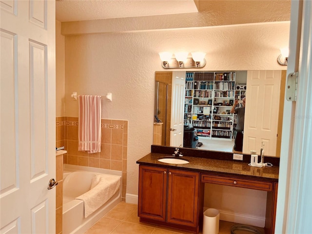 184 Banyan Bay Dr, Saint Petersburg, FL 33705 - bathroom with a shower stall, tile patterned flooring, a garden tub, vanity, and a textured ceiling