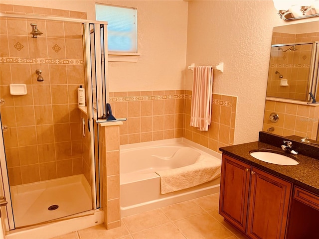 184 Banyan Bay Dr, Saint Petersburg, FL 33705 - full bath with a bath, a stall shower, vanity, tile patterned floors, and a textured wall