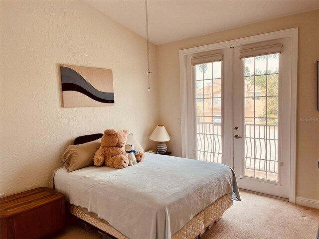 184 Banyan Bay Dr, Saint Petersburg, FL 33705 - carpeted bedroom with access to outside, lofted ceiling, and baseboards
