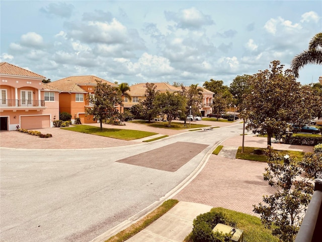 184 Banyan Bay Dr, Saint Petersburg, FL 33705 - view of asphalt street featuring a residential view, curbs, and sidewalks