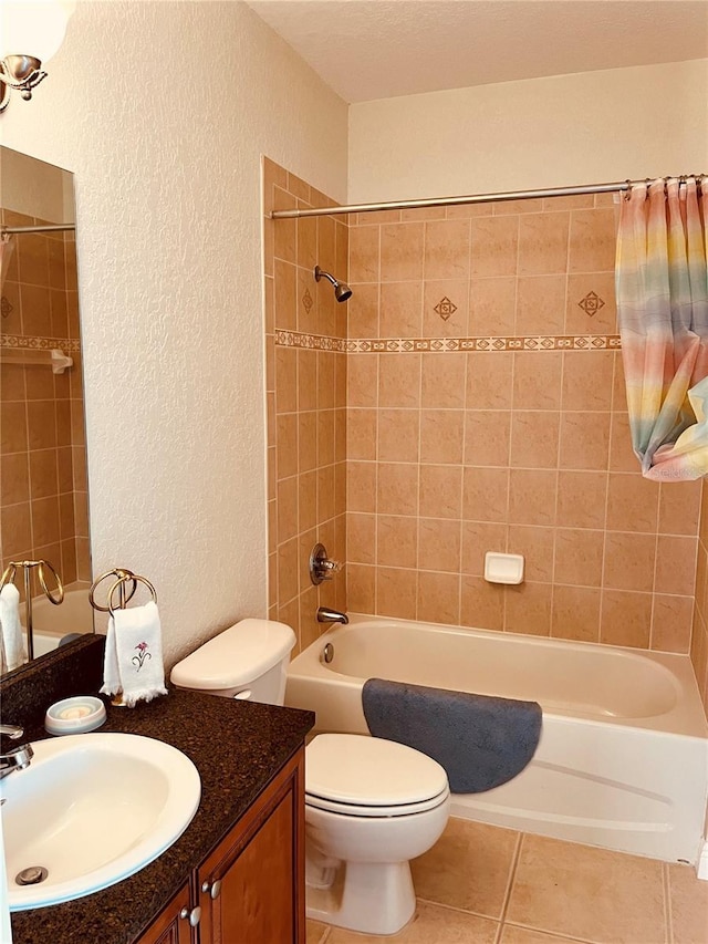 184 Banyan Bay Dr, Saint Petersburg, FL 33705 - full bathroom with a textured wall, toilet, tile patterned floors, shower / bathtub combination, and vanity