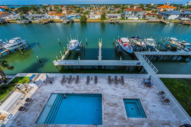 dock area with boat lift and a water view