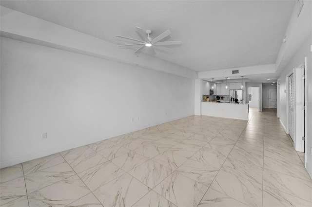 unfurnished living room with a ceiling fan and light marble finish floors