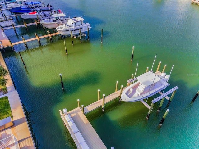 dock area featuring boat lift and a water view