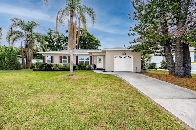 119 N Hillcrest Ave, Clearwater, FL 33755 - ranch-style home featuring an attached garage, driveway, stucco siding, and a front yard