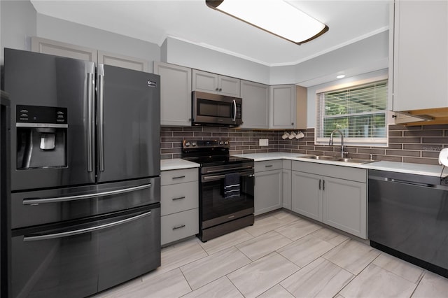 119 N Hillcrest Ave, Clearwater, FL 33755 - kitchen featuring appliances with stainless steel finishes, a sink, gray cabinetry, light countertops, and tasteful backsplash