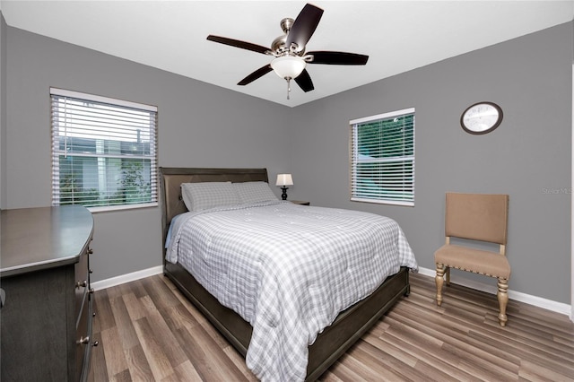 119 N Hillcrest Ave, Clearwater, FL 33755 - bedroom with baseboards, wood finished floors, and a ceiling fan