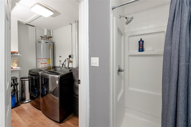 119 N Hillcrest Ave, Clearwater, FL 33755 - laundry room with washing machine and clothes dryer, water heater, and wood finished floors
