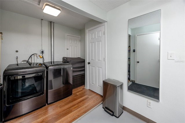 119 N Hillcrest Ave, Clearwater, FL 33755 - clothes washing area with washing machine and clothes dryer, baseboards, and a textured ceiling