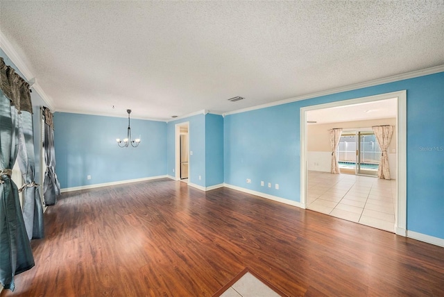 16201 Country Crossing Dr, Tampa, FL 33624 - unfurnished living room featuring a chandelier, crown molding, wood finished floors, a textured ceiling, and baseboards