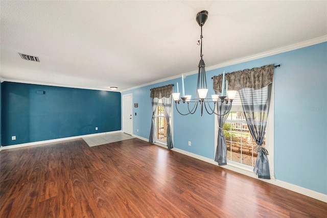 16201 Country Crossing Dr, Tampa, FL 33624 - unfurnished room featuring a chandelier, crown molding, wood finished floors, and baseboards