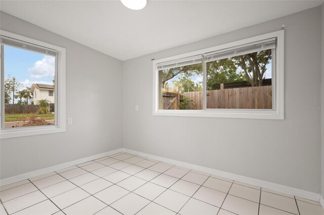 1858 Oregon Ave NE, Saint Petersburg, FL 33703 - unfurnished room with baseboards and light tile patterned floors