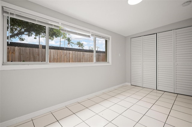 1858 Oregon Ave NE, Saint Petersburg, FL 33703 - unfurnished bedroom with baseboards, lofted ceiling, a closet, and light tile patterned floors