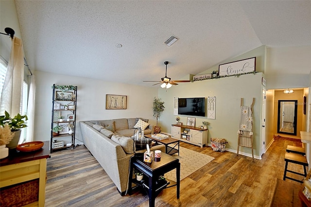 759 Cape Cod Cir, Valrico, FL 33594 - living area featuring ceiling fan, wood finished floors, lofted ceiling, and a textured ceiling