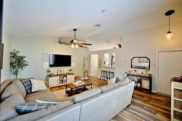 759 Cape Cod Cir, Valrico, FL 33594 - living area featuring ceiling fan, vaulted ceiling, wood finished floors, a textured ceiling, and baseboards