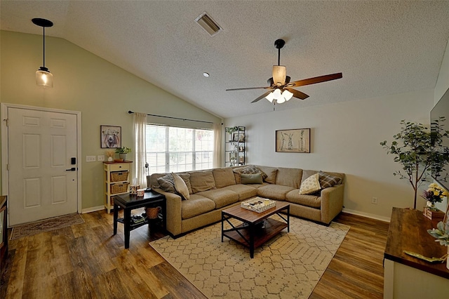 759 Cape Cod Cir, Valrico, FL 33594 - living area with a textured ceiling, lofted ceiling, ceiling fan, wood finished floors, and baseboards
