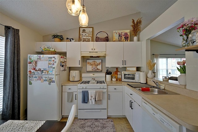 759 Cape Cod Cir, Valrico, FL 33594 - kitchen with white appliances, vaulted ceiling, a sink, under cabinet range hood, and light countertops