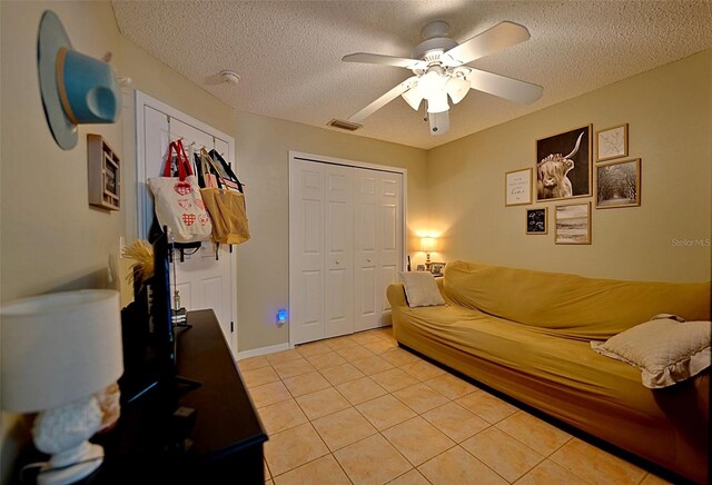 759 Cape Cod Cir, Valrico, FL 33594 - living room featuring a textured ceiling, ceiling fan, and light tile patterned floors