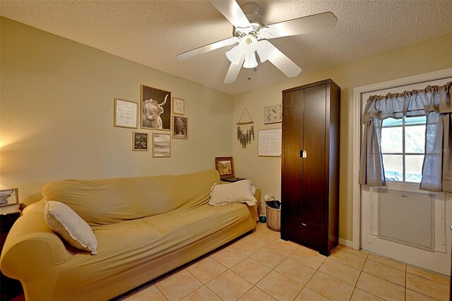 759 Cape Cod Cir, Valrico, FL 33594 - living area featuring a textured ceiling, light tile patterned floors, and a ceiling fan