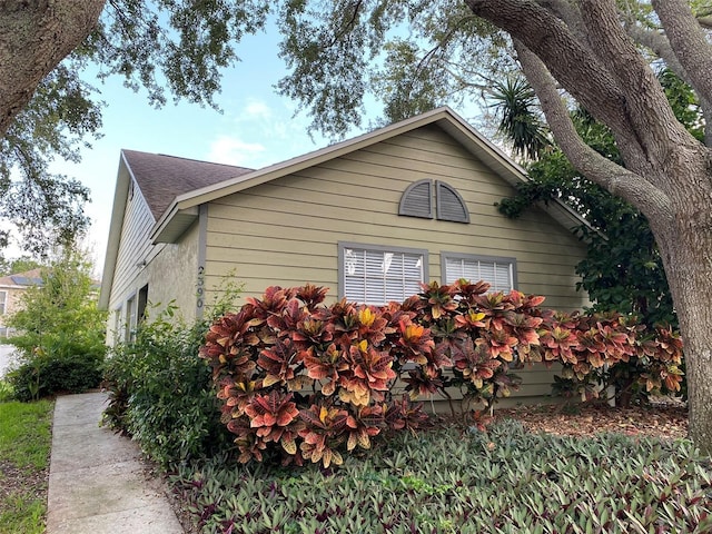 2390 Bentley Dr, Palm Harbor, FL 34684 - view of property exterior featuring roof with shingles