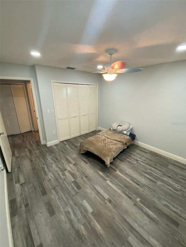 2390 Bentley Dr, Palm Harbor, FL 34684 - unfurnished bedroom featuring baseboards, wood finished floors, recessed lighting, ceiling fan, and a closet