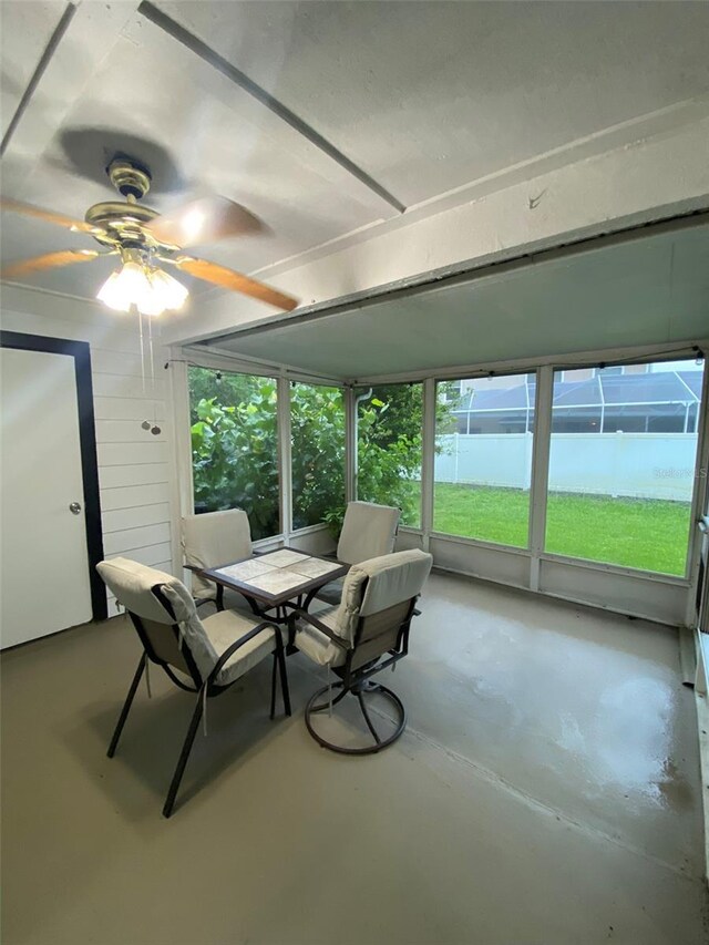 2390 Bentley Dr, Palm Harbor, FL 34684 - sunroom / solarium with ceiling fan and outdoor dining space