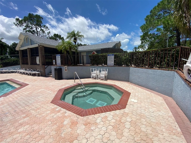 2390 Bentley Dr, Palm Harbor, FL 34684 - view of pool featuring a community hot tub, fence, a patio area, and a swimming pool