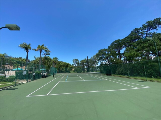 2390 Bentley Dr, Palm Harbor, FL 34684 - view of tennis court with fence and community basketball court