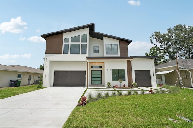 3817 W San Nicholas St, Tampa, FL 33629 - modern home featuring stucco siding, an attached garage, concrete driveway, and a front lawn