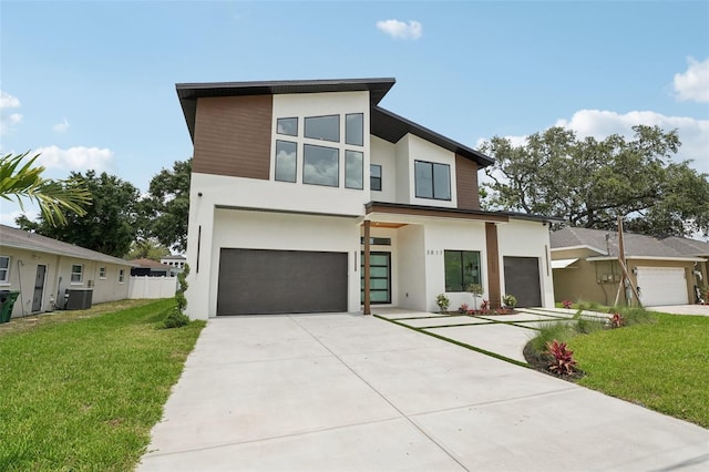 3817 W San Nicholas St, Tampa, FL 33629 - modern home with stucco siding, driveway, an attached garage, a front yard, and central AC unit