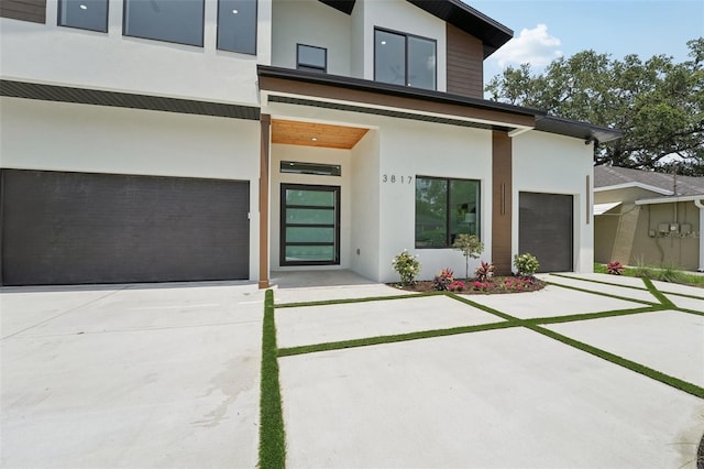 3817 W San Nicholas St, Tampa, FL 33629 - view of exterior entry featuring stucco siding, concrete driveway, and an attached garage