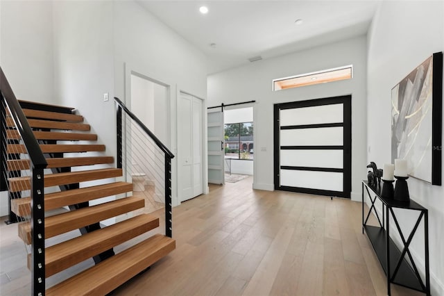 3817 W San Nicholas St, Tampa, FL 33629 - entrance foyer featuring a barn door, stairway, light wood-type flooring, a high ceiling, and recessed lighting
