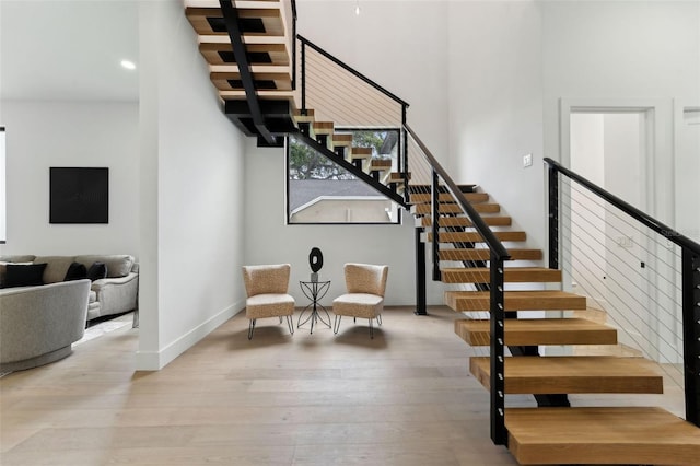 3817 W San Nicholas St, Tampa, FL 33629 - stairway featuring hardwood / wood-style flooring, baseboards, a towering ceiling, and recessed lighting