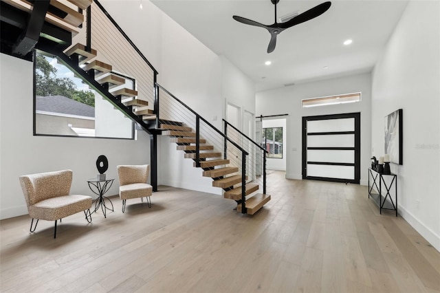 3817 W San Nicholas St, Tampa, FL 33629 - foyer entrance with stairway, a high ceiling, hardwood / wood-style flooring, a ceiling fan, and baseboards