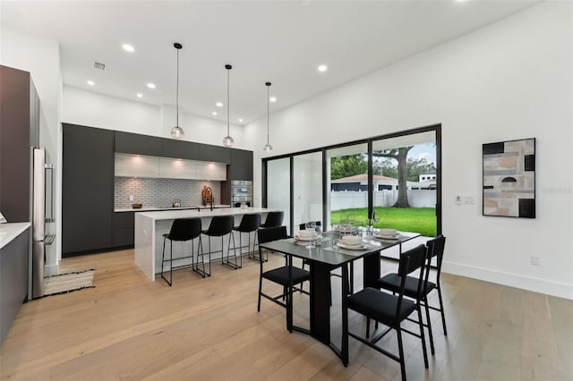 3817 W San Nicholas St, Tampa, FL 33629 - dining room featuring recessed lighting, light wood finished floors, a high ceiling, and baseboards