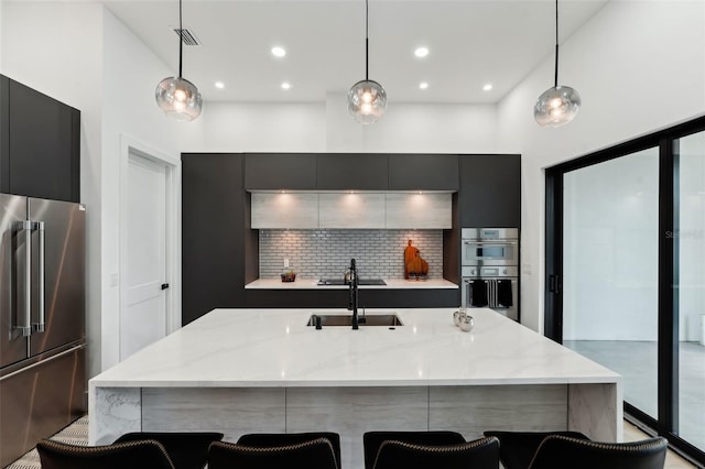 3817 W San Nicholas St, Tampa, FL 33629 - kitchen with stainless steel appliances, a breakfast bar area, a sink, modern cabinets, and light stone countertops