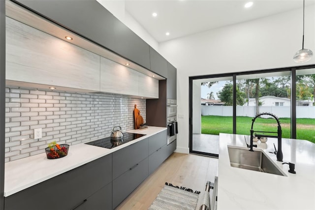 3817 W San Nicholas St, Tampa, FL 33629 - kitchen with a sink, black electric stovetop, modern cabinets, gray cabinetry, and recessed lighting