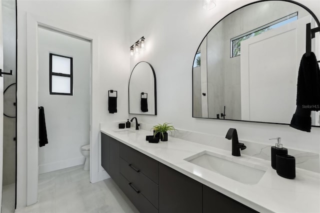 3817 W San Nicholas St, Tampa, FL 33629 - full bathroom with toilet, double vanity, and baseboards