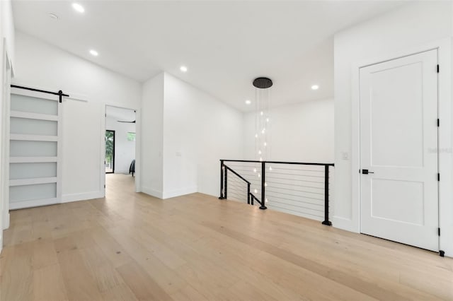 3817 W San Nicholas St, Tampa, FL 33629 - spare room featuring a barn door, light wood-style flooring, recessed lighting, and baseboards