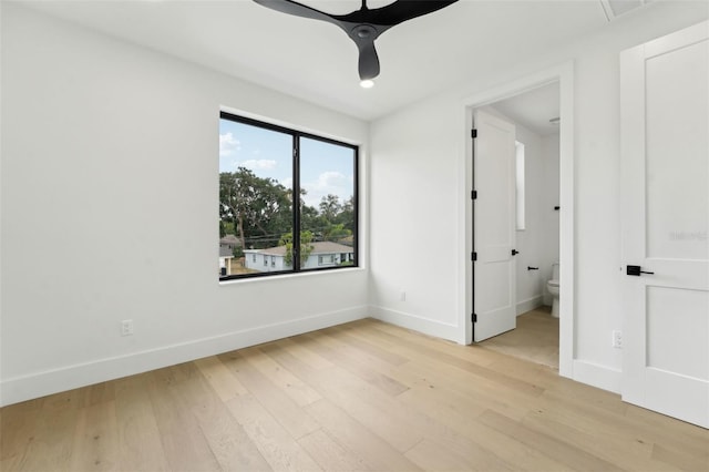 3817 W San Nicholas St, Tampa, FL 33629 - unfurnished bedroom featuring light wood-style floors, baseboards, and ensuite bathroom