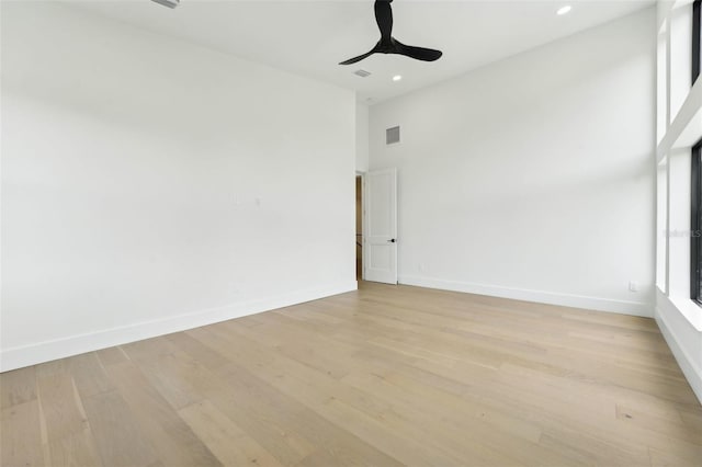 3817 W San Nicholas St, Tampa, FL 33629 - empty room with light wood finished floors, baseboards, recessed lighting, ceiling fan, and a high ceiling
