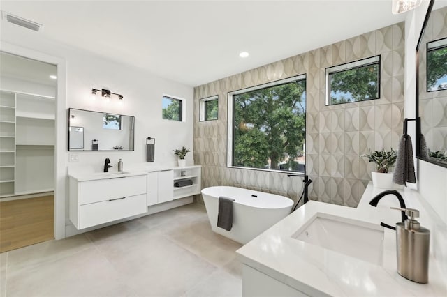 3817 W San Nicholas St, Tampa, FL 33629 - bathroom with a soaking tub, vanity, and tile patterned floors