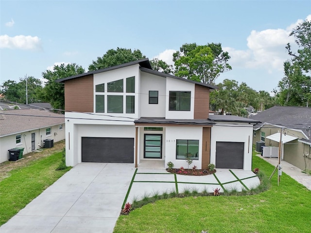 3817 W San Nicholas St, Tampa, FL 33629 - contemporary house with stucco siding, central AC unit, a garage, and a front yard