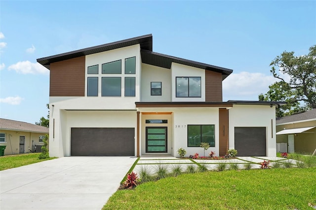 3817 W San Nicholas St, Tampa, FL 33629 - contemporary home with stucco siding, a garage, driveway, and a front lawn
