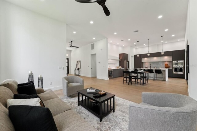 3817 W San Nicholas St, Tampa, FL 33629 - living room with a ceiling fan, recessed lighting, light wood-style floors, and beverage cooler