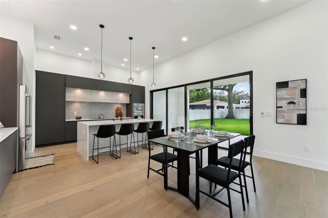 3817 W San Nicholas St, Tampa, FL 33629 - dining area with recessed lighting, light wood-style floors, and a towering ceiling